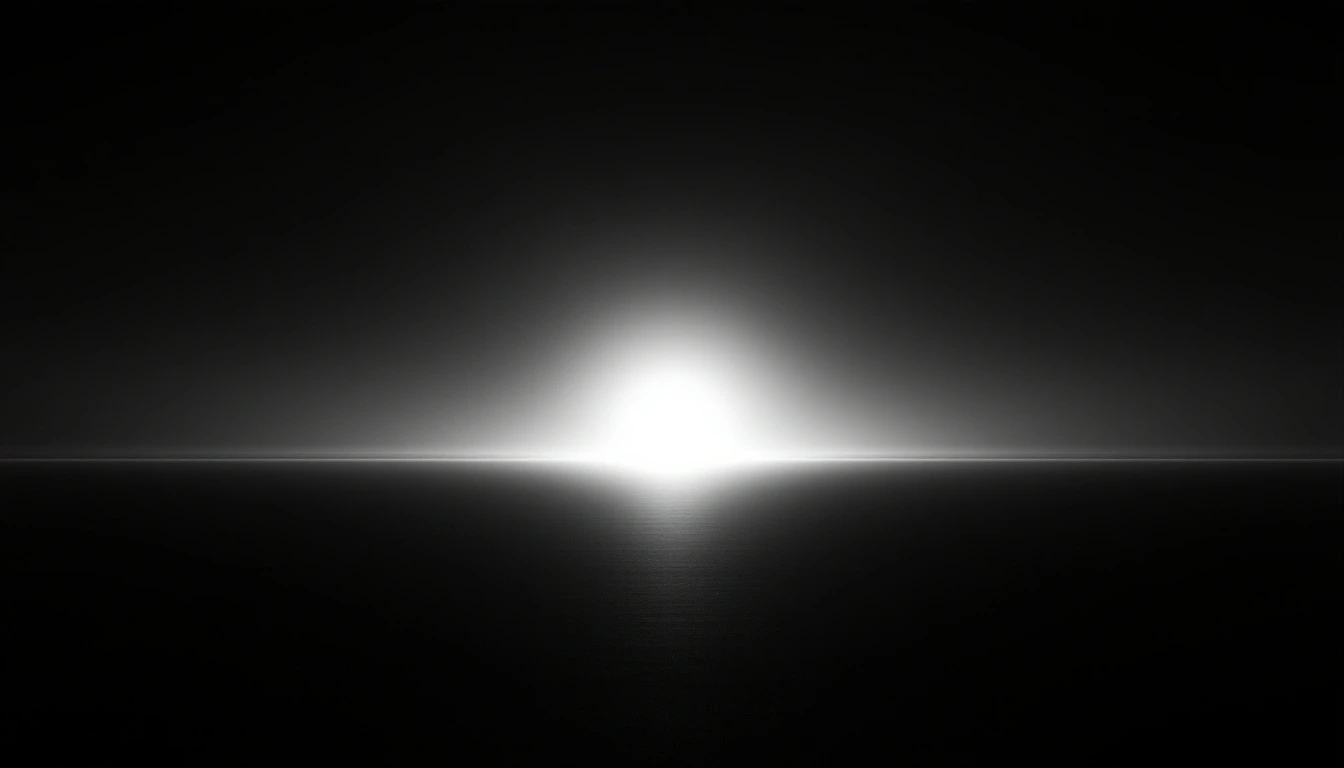Black and white photograph of first light breaking over a flat horizon into a dark sky